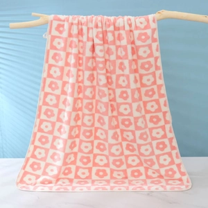 Soft coral fleece towel featuring a pink and white checkerboard floral pattern design