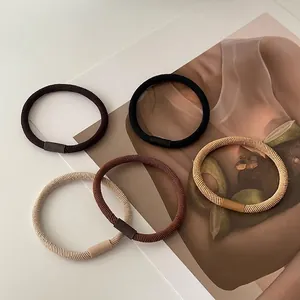 Set of 5 minimalist earth-toned elastic hair ties with textured ribbed weave design
