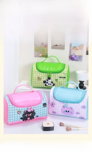 Close-up of portable cartoon cosmetic bags with handle, sturdy double zipper and cute charms