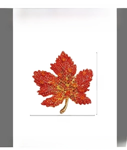 Detailed view of red maple leaf brooch with orange crystals measuring 5.2cm x 4.7cm