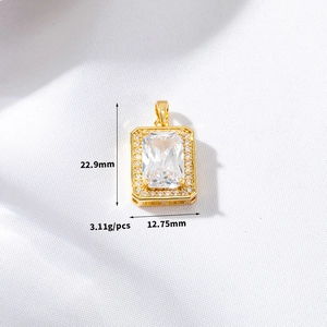 Macro shot of rectangular gold pendant with clear gemstone and dimensions 22.9x12.75mm