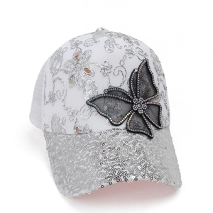 Detail of white baseball cap with silver sequins, floral embroidery and butterfly patch