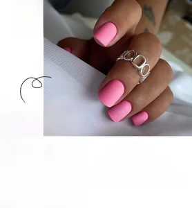 Close-up of matte pink square press-on nails with frosted texture and full size range
