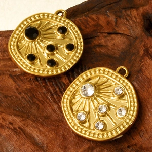Macro shot of 18k gold plated 304 stainless steel pendants with black and clear crystals