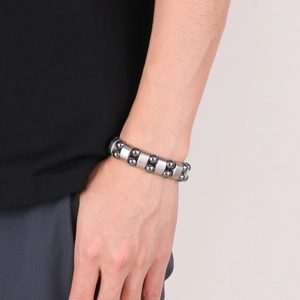 Detail of men's double-row gray stone beads with matte steel connectors on wrist