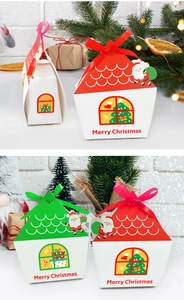 Detail of house-shaped Christmas gift boxes with ribbons and Merry Christmas print