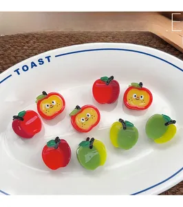 Macro view of assorted resin apple charms for hair clips and DIY accessories