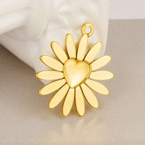 18k gold plated 304 stainless steel daisy pendant with heart relief on white sculpture
