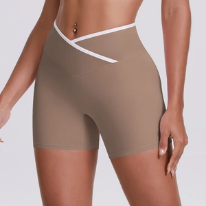 Macro detail of high-waist yoga shorts showing the white cross-waist design and coffee fabric