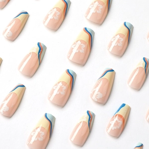 French tip press-on nails with blue yellow waves and white floral patterns