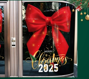 Detail of red ribbon bow window sticker with gold Merry Christmas 2025 typography