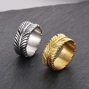 Detailed view of feather texture on stainless steel rings in silver and gold finish