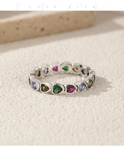 Macro shot of S925 sterling silver eternity band with colorful heart-shaped gemstones