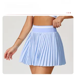 Detailed view of light blue tennis skirt featuring sharp accordion pleats and waist stripes