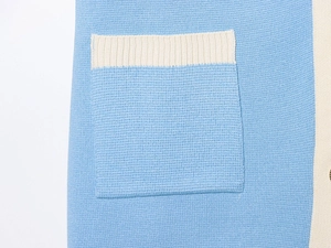 Detail of a square pocket on a knit shirt featuring blue and beige color-block design