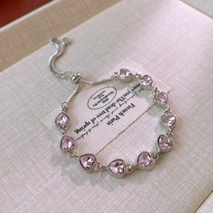 Detail of adjustable silver bolo bracelet featuring pink zircon hearts and beaded settings