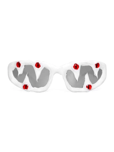 Detail of unique white jagged sunglasses with realistic red eyeball 3D accents and gray lenses