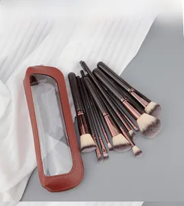 Close-up of 12 makeup brushes with rose gold ferrules in a brown transparent window pouch