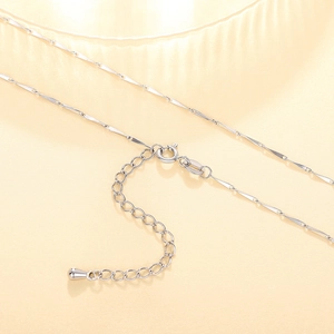 Detail of silver twisted flat chain with spring clasp and waterdrop pendant charm