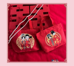 Detail of red wedding canvas tote bags with cartoon bride and groom prints