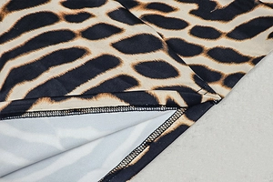 Detailed close-up of leopard print fabric texture and high-quality hem stitching