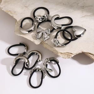 Silver 18k stainless steel hair ties with heart and bow charms on black elastic bands