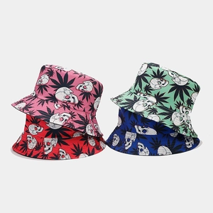 Detail view of four patterned bucket hats in pink, red, mint green, and navy blue