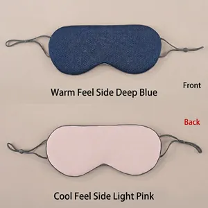 Detail of dual-sided sleep mask showing warm blue mesh and cool pink silk fabric