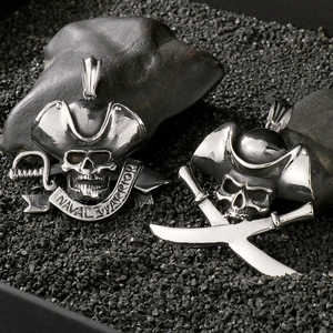 Detailed view of silver pirate skull pendants with swords on a dark textured background