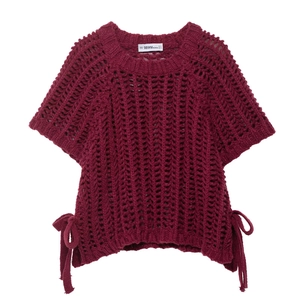 Detail of burgundy open knit short sleeve top with side lace-up ties and textured pattern