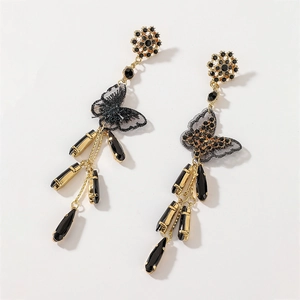 Detail of gold fringe earrings with black crystal butterflies and teardrop charms