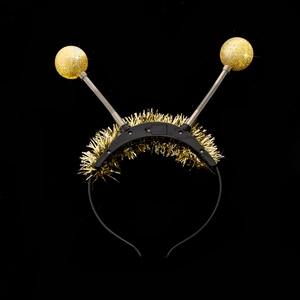 Close-up of LED alien headband with gold glitter balls and internal battery compartment