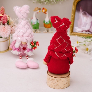 Detail of plush gnome dolls with sequin hats and hanging legs for Valentine's Day decor