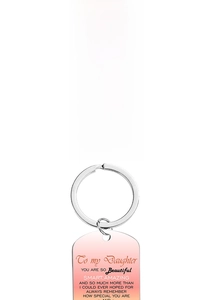 Detail of laser engraved stainless steel dog tag keychains with colorful gradients for daughter
