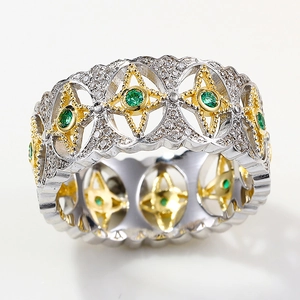 Detailed macro view of vintage two-tone hollow ring with green gemstone and white diamonds