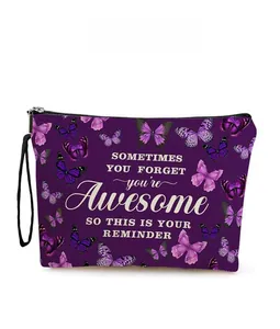 Macro shot of purple butterfly makeup bag with motivational text and black wrist strap