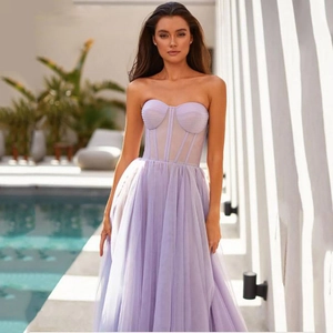 Close-up of lavender strapless evening gown with sheer boned bodice and layered tulle skirt