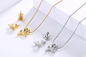 Close-up of rose flower jewelry set with snake chain in gold and silver steel finish