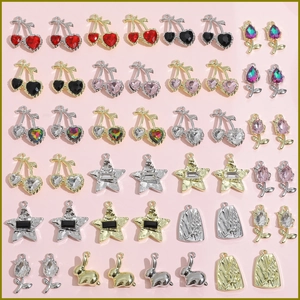 Macro detail of Y2K style cherry, tulip, and star charms for DIY jewelry making