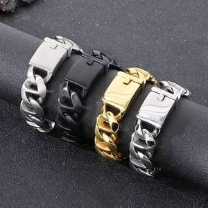 Detail of Cuban chain bracelets in gold, black, and silver finishes on display