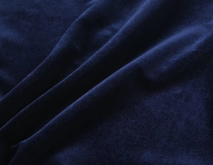 Detailed macro view of dark blue velvet fabric with soft texture and elegant sheen