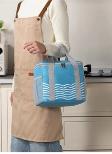 Detail of blue insulated lunch bag with white wave pattern and mesh side pocket