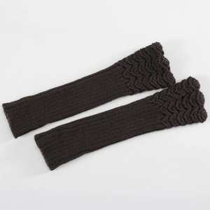 Detailed knit texture of dark coffee arm warmers with wavy edges on white background