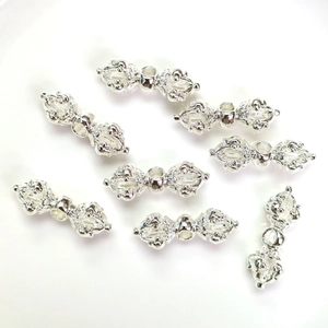 Eight silver 14K gold filled Vajra beads for DIY jewelry making on white background