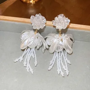Elegant white flower tassel earrings with mother-of-pearl luster petals and gold finish