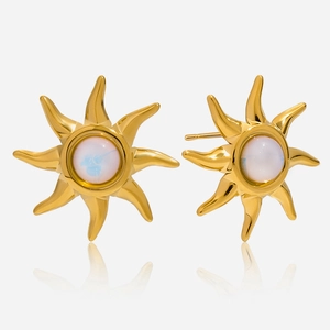 Detailed macro shot of 18K gold plated sunburst earrings with white opal stones and reflections