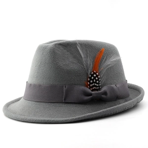 Detail of gray wool felt fedora featuring a grosgrain ribbon bow and vibrant orange feathers