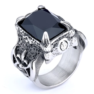Macro detail of gothic signet ring with square black gemstone and claw setting
