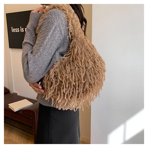 Chic khaki faux fur shoulder bag with soft plush texture worn over a grey sweater
