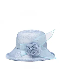 Close-up of sky blue sun hat side detail with mesh fabric flower and white floral patterns